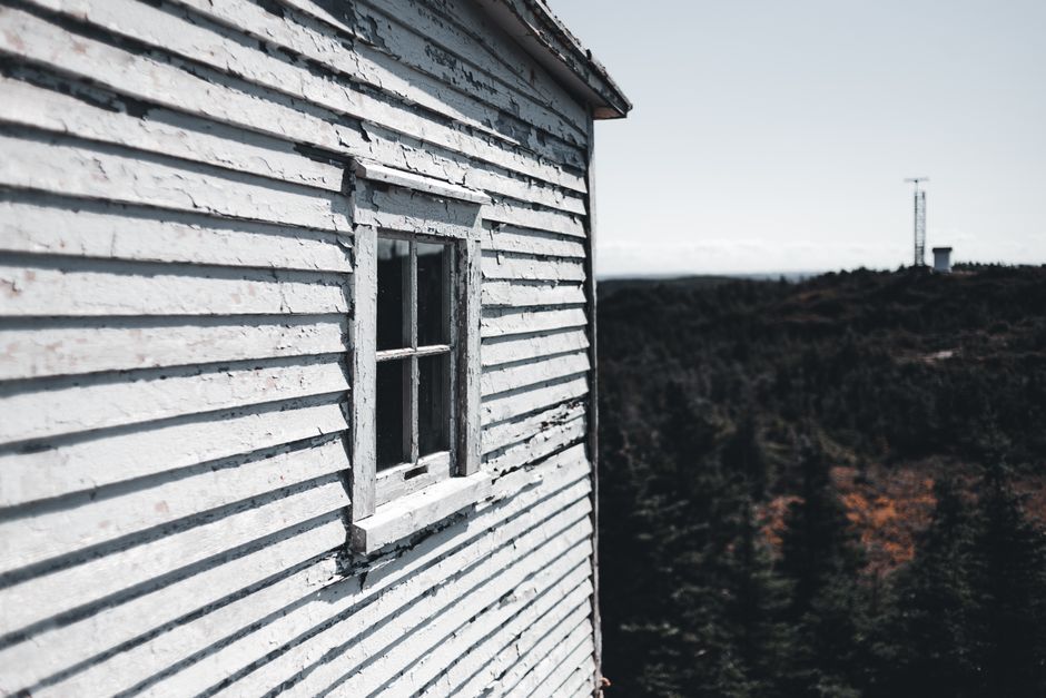 A wooden house with peeling paint